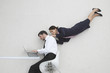 businessman and businesswoman using laptop, portrait, elevated view