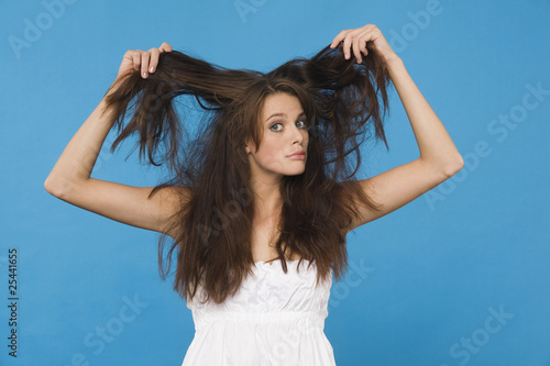 Photo: young woman tearing her hair, portrait young woman tearing her hair, portrait