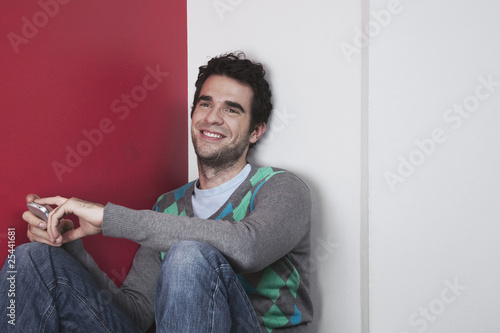 Photo: man holding mobile phone, smiling man holding mobile phone, smiling