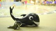 Big inflatable whale and small whale is near pool in water park Big inflatable whale and small whale is near pool in water park
