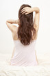 girl on the bed brushing her hair