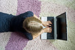 Girl lying on the floor and using her notebook