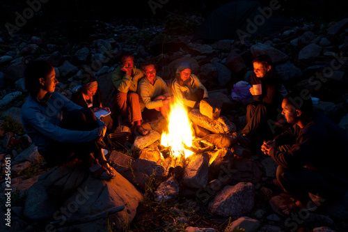 Foto: People near campfire in forest. People near campfire in forest.
