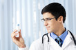 Happy doctor with drug, at office