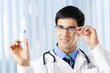Happy doctor with drug, at office