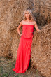 Beautiful blond woman near haystack