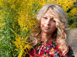 Beautiful blond young woman with wild flowers