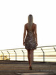 Blond lady walking over promenade