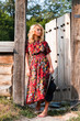 Beautiful blond young woman in the wooden gate