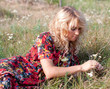 Beautiful blond young woman with wild flowers