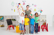 diverse young  students with teacher waving flags