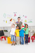 happy preschoolers and teaching waving flags in classroom