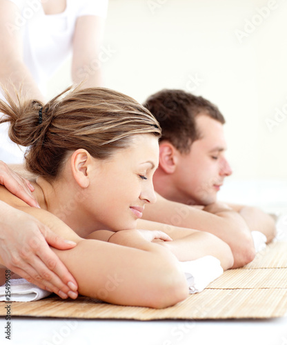 Photo: Relaxed young couple receiving a back massage Relaxed young couple receiving a back massage