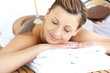 Relaxed young woman enjoying a beauty treatment with mud