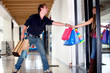 Man keeping a woman from entering a store