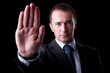 Businessman with his hand raised in signal to stop