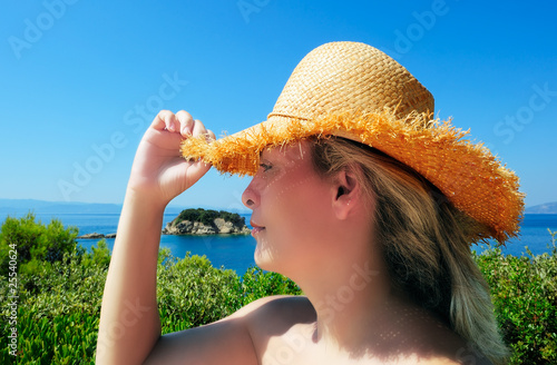 Attractive woman in straw hat during her Mediterranean holidays