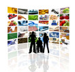 People in front of wall of tv screens