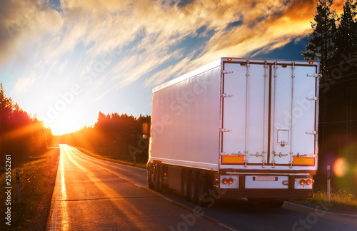 Photo: White truck on the asphalt road in the evening White truck on the asphalt road in the evening