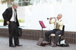 Businessman giving money to the musician