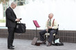 Businessman tipping the musician