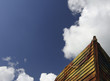 Wooden boat bow against blue cloudy sky