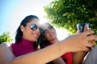 two friends looking at cell phone two friends looking at cell phone