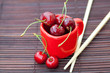 cherry cup and chopsticks on bamboo mat cherry cup and chopsticks on bamboo mat