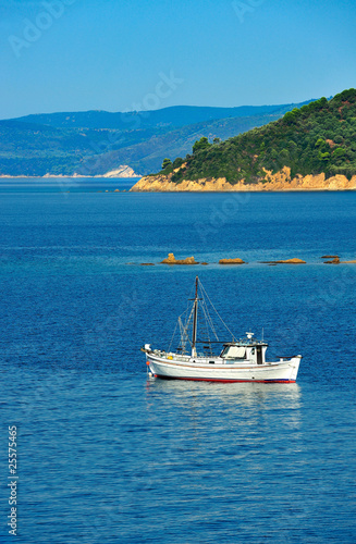 Fishing trawler among Greek islands Fishing trawler among Greek islands