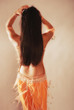 Belly dancer moving hips in orange costume