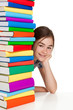 Student sitting behind pile of books on white