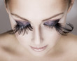 Photo: Closeup of young beautiful woman wearing false feather eyelashe Closeup of young beautiful woman wearing false feather eyelashe