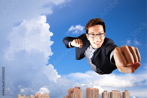 Photo: businessman fly in sky over the city businessman fly in sky over the city