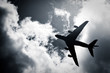 large passenger jet silhouette against clouds