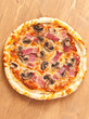 whole bacon and mushroom pizza on a table