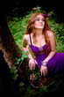 redhaired girl collecting mushrooms in wood