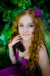 Portrait of the redhaired girl in wood