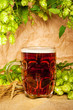 beer mug with hop and wheat on sacking still-life beer mug with hop and wheat on sacking still-life