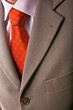 Detail of perfect business man grey suit with red tie. Detail of perfect business man grey suit with red tie.