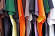 Row of colorful cotton t-shirts. Clothes background. Row of colorful cotton t-shirts. Clothes background.