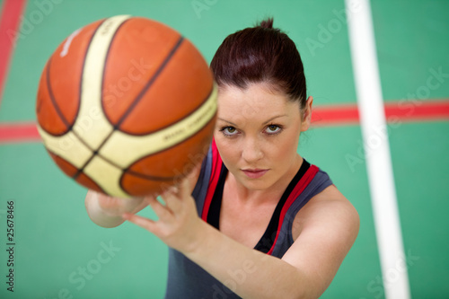 Photo: Portrait of an athletic young woman playing basket-ball Portrait of an athletic young woman playing basket-ball