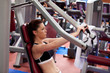 Attractive athletic woman using a bench press