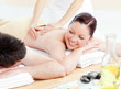 Glowing young couple receiving a back massage Glowing young couple receiving a back massage