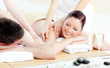 Positive young couple enjoying a back massage Positive young couple enjoying a back massage