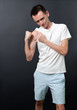 Skinny man showing his muscles