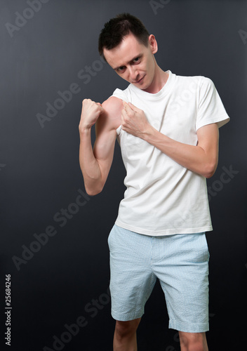 Photo: Skinny man showing his muscles Skinny man showing his muscles
