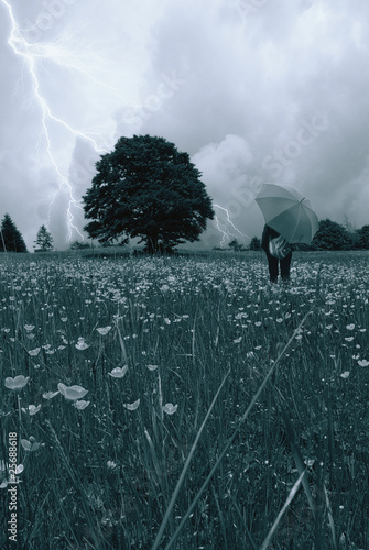 Photo: woman in the meadow with umbrella woman in the meadow with umbrella