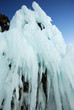 Ice-covered cape rocks of the lake shore with icicles Ice-covered cape rocks of the lake shore with icicles