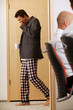 businessmen walkin across the corridor with pijamas pants