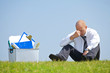 fired businessman sitting in park